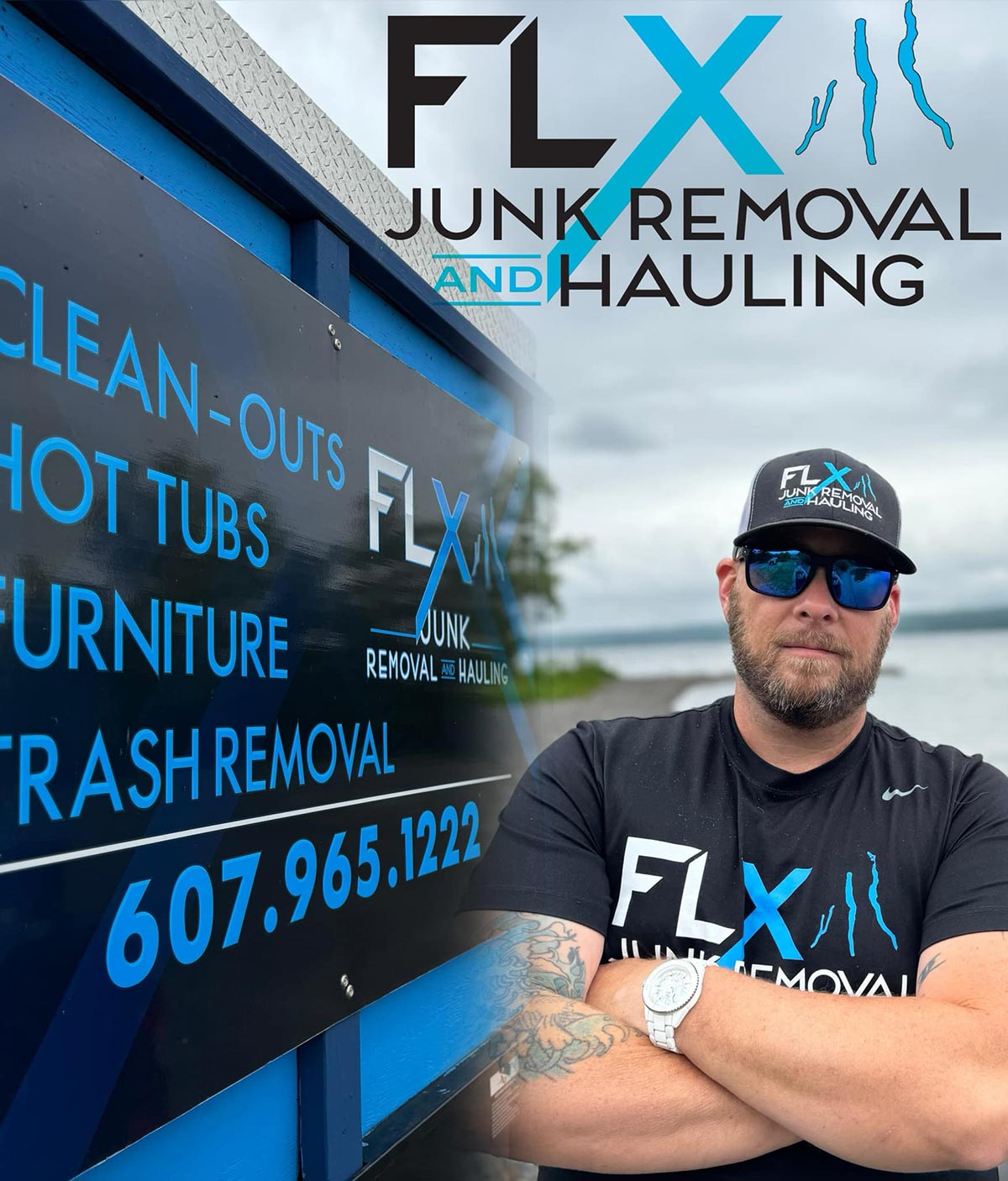 Man wearing sunglasses, a black cap and T-shirt with "FLX Junk Removal" logo, standing with crossed arms next to a sign advertising junk removal services, near a body of water on a cloudy day.